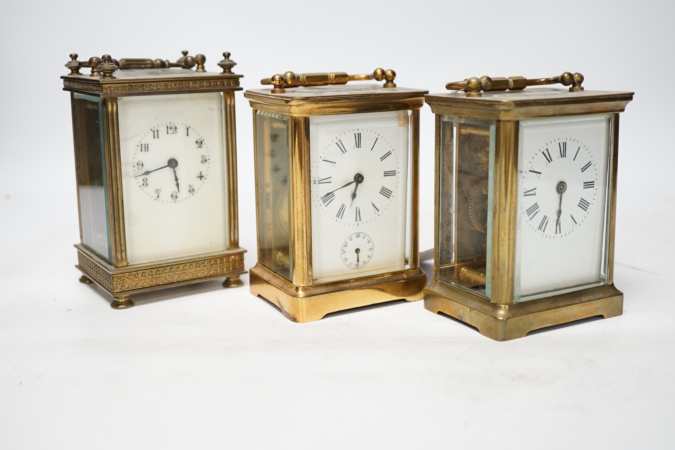 Three carriage timepieces with enamel dials, largest 14.5cm high. Condition - poor to fair